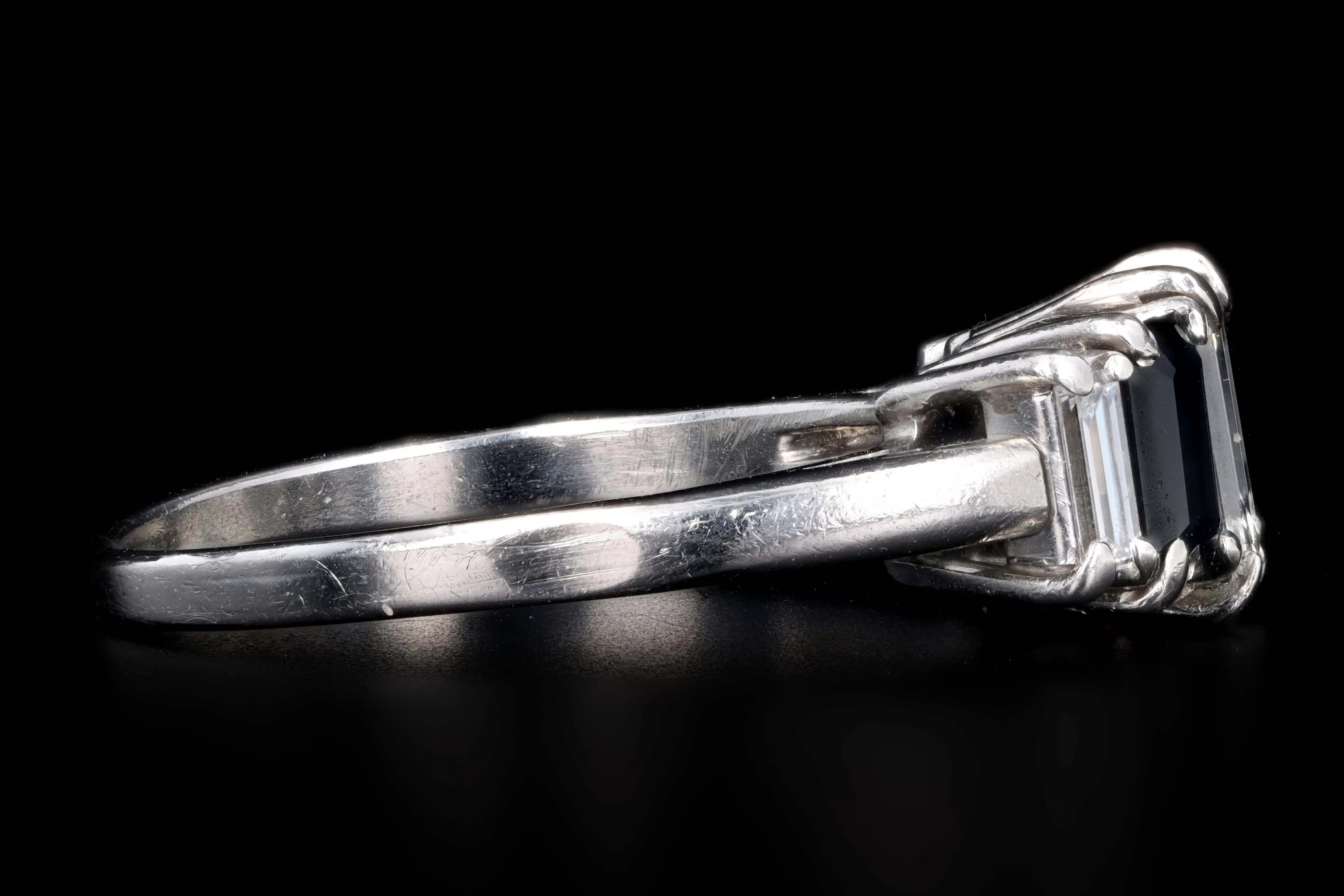 Modern Platinum .70 CTR Emerald Cut Diamond and Sapphire Ring