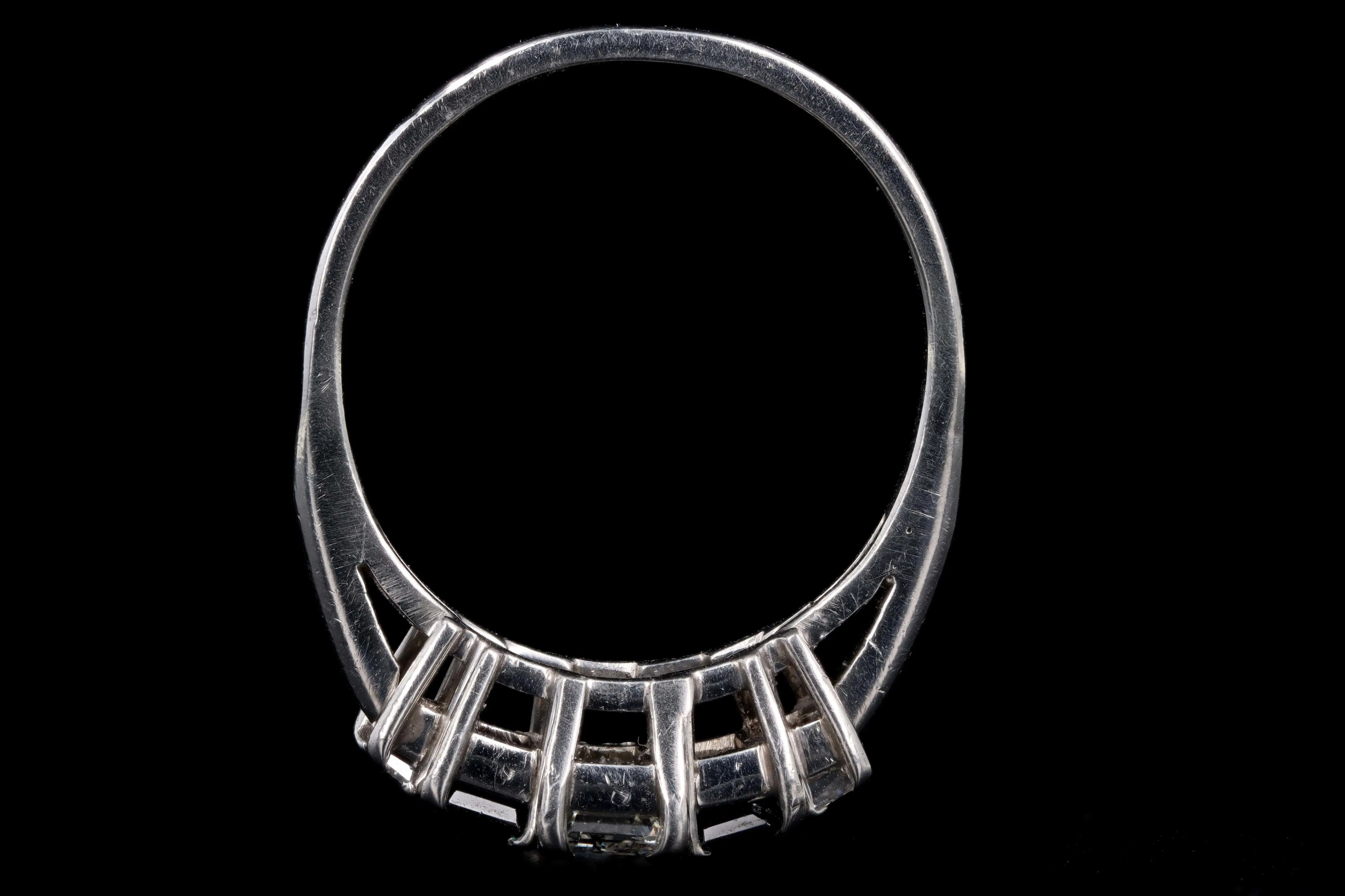 Modern Platinum .70 CTR Emerald Cut Diamond and Sapphire Ring