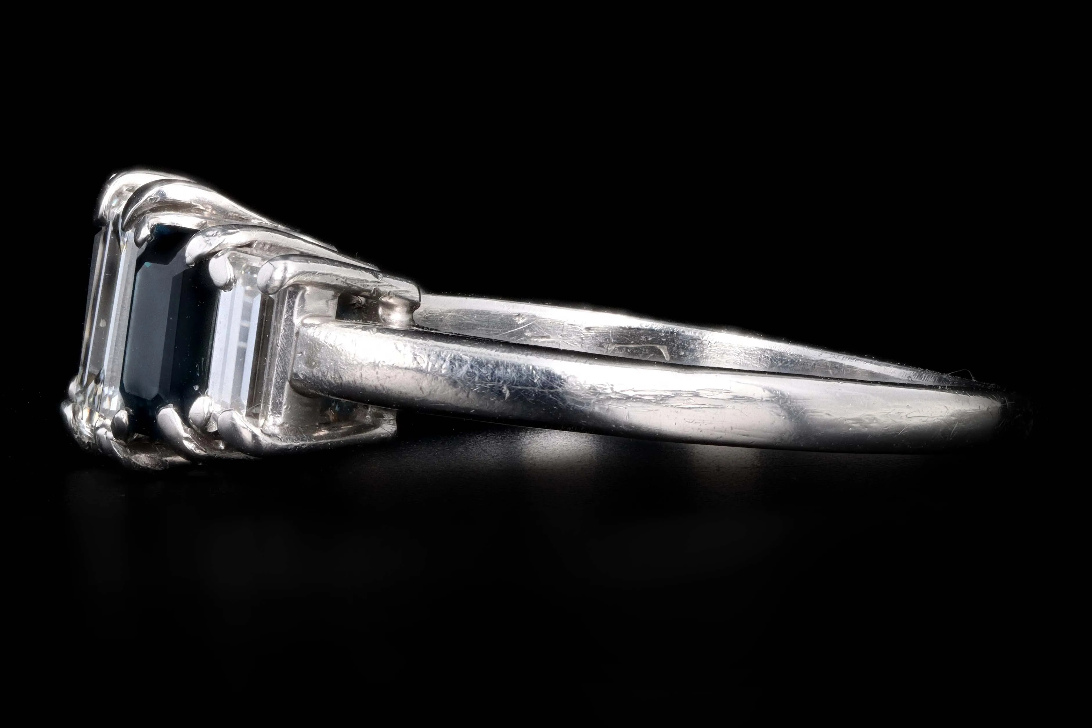 Modern Platinum .70 CTR Emerald Cut Diamond and Sapphire Ring